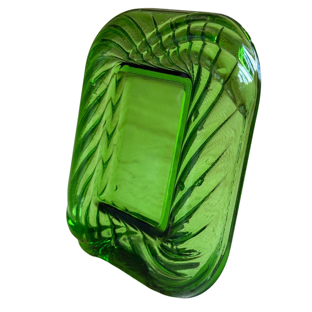 A green glass picture frame with a textured, ribbed pattern around a rectangular center opening, shown on a plain white background.