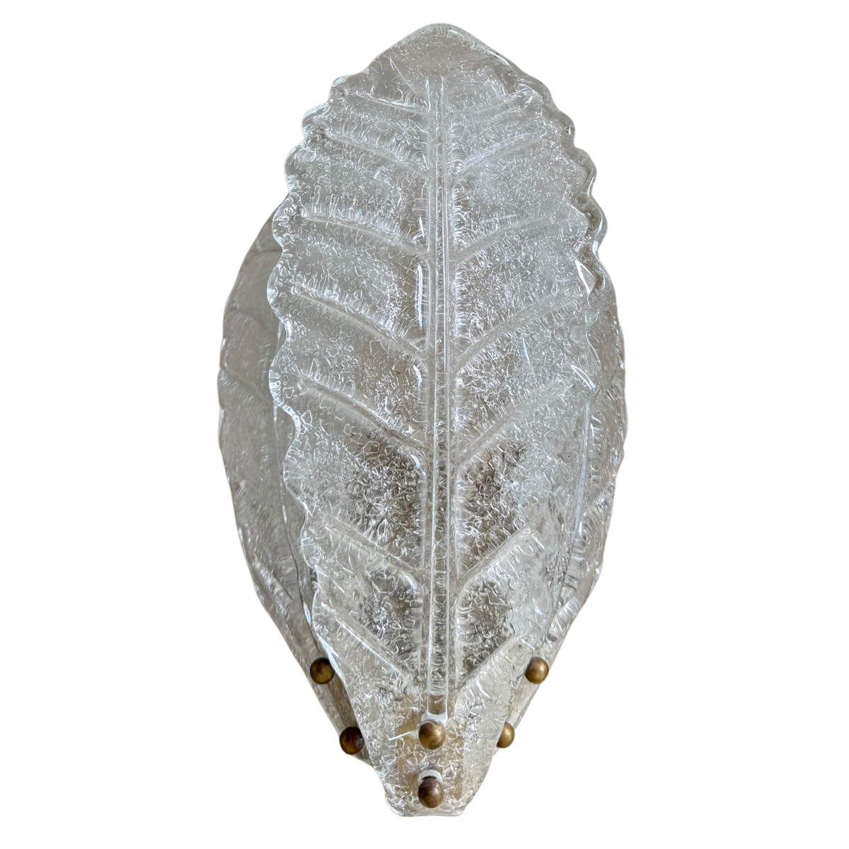 A clear, textured glass wall sconce shaped like a leaf, featuring a central vein pattern and small metallic gold finials at the tip.