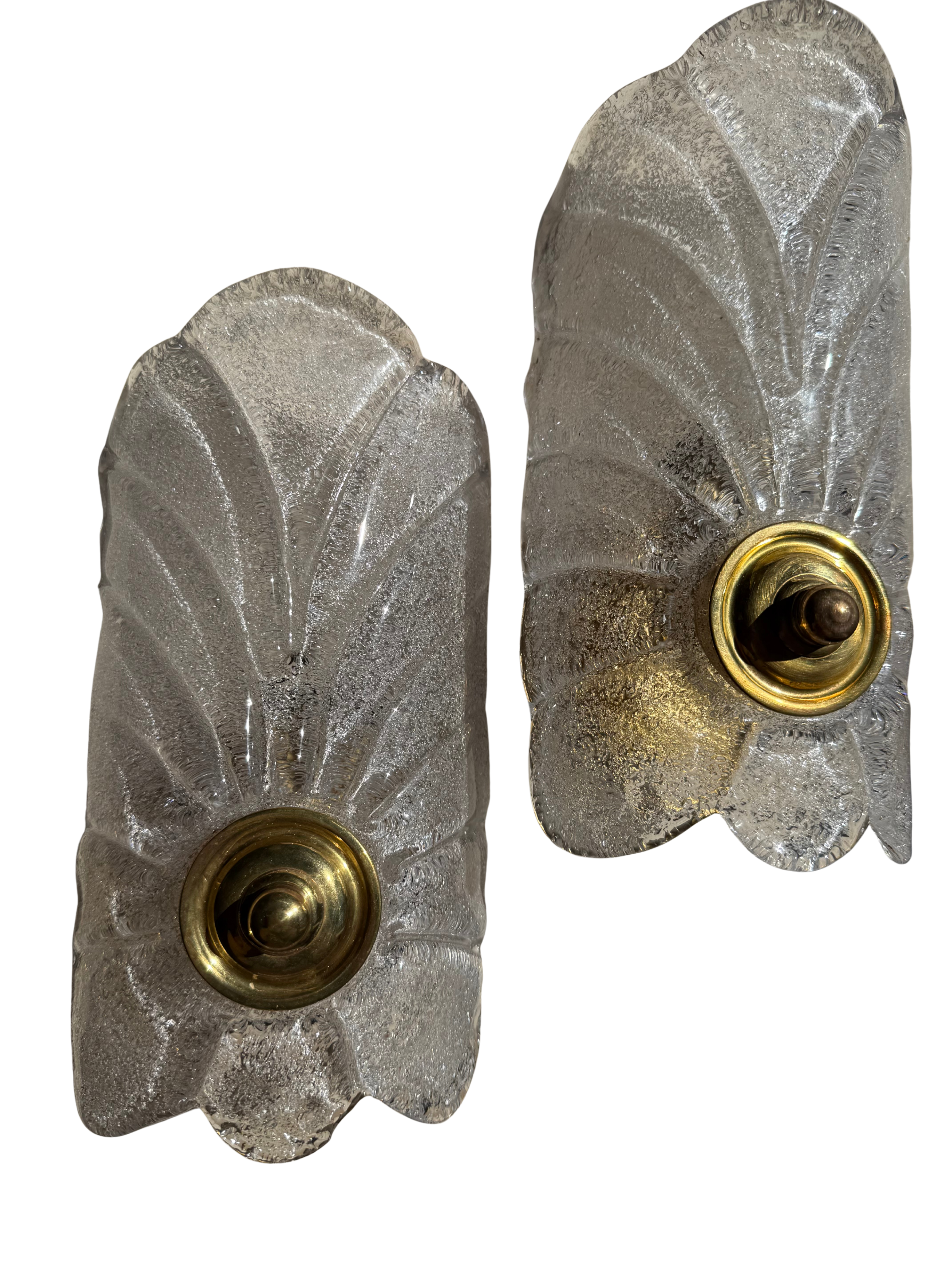 A pair of vintage Art Deco wall sconces featuring textured, frosted glass panels with a brushed brass or gold metal socket at the base, shown against a plain white background.